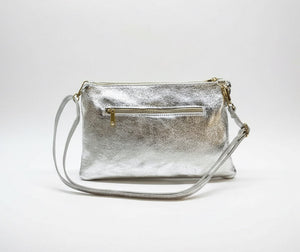 Silver handbag with a strap on a white background