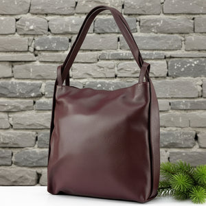 Brown leather handbag on a white background
