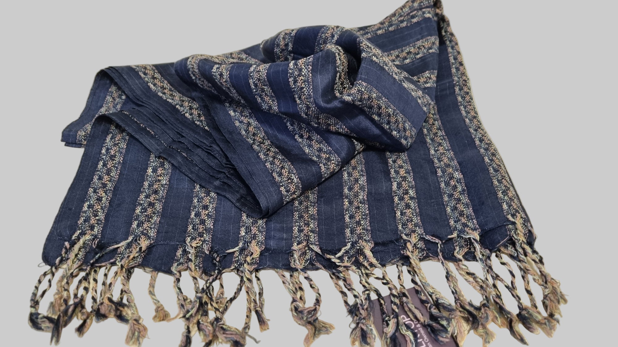 Blue striped scarf with fringes on a beige background