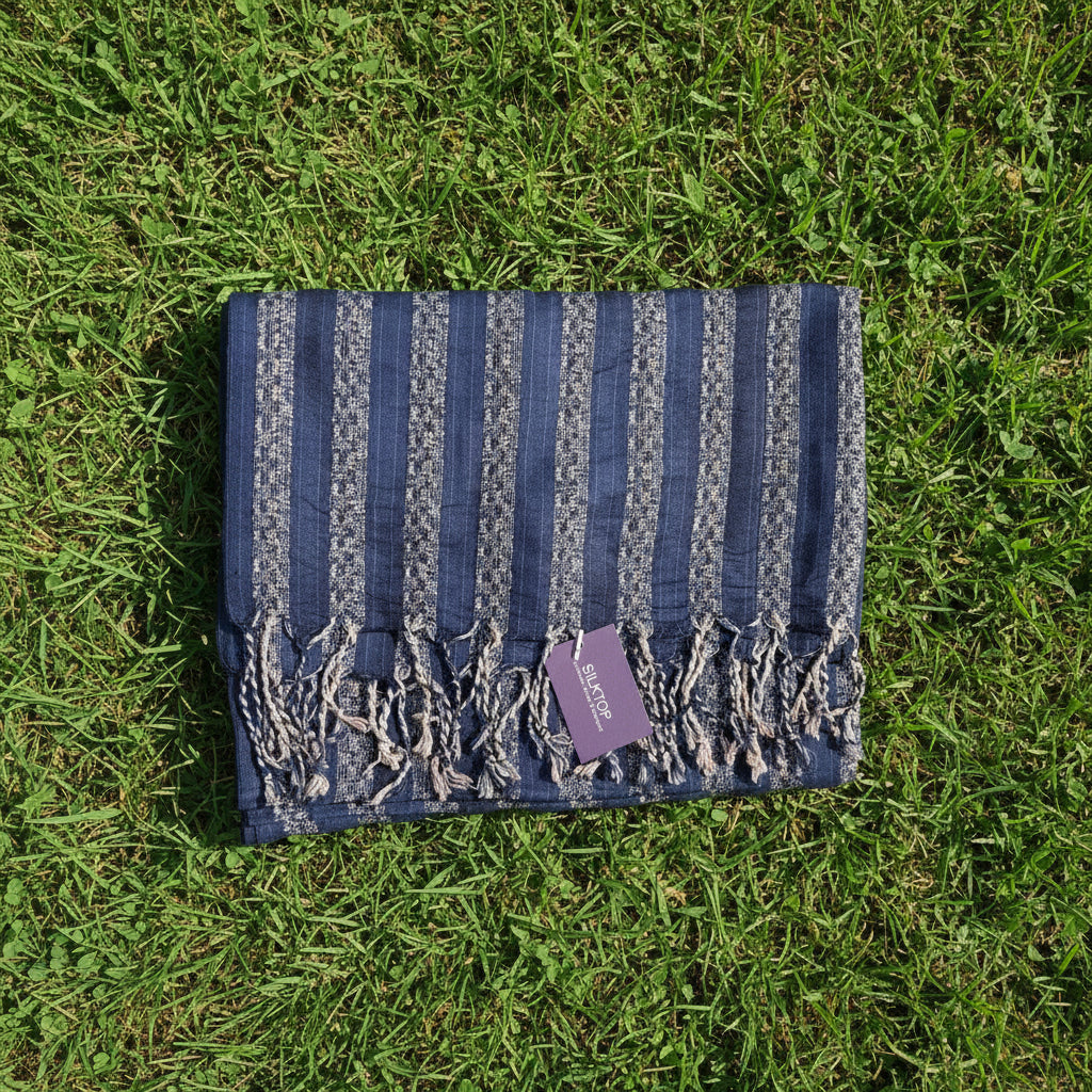 Patterned blue fabric on a beige pillow with a visible tag.