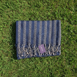 Patterned blue fabric on a beige pillow with a visible tag.