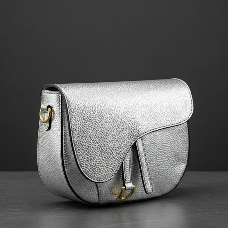 Silver handbag with gold accents on a white background