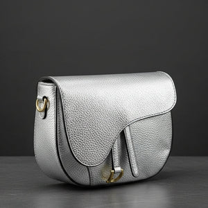 Silver handbag with gold accents on a white background